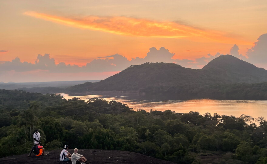 Sunset casts a warm glow over Colombia's remote Mavecure Mountains, where three towering rock formations rise above the Amazon jungle.