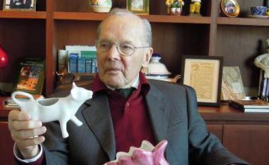 Chuck Williams in 2011 in his San Francisco office with a painted water pitcher in the form of a chicken and other items from his collection.