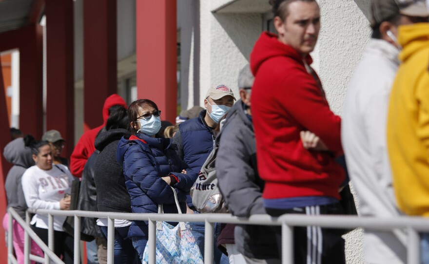 People wait in line for help with unemployment benefits at the One-Stop Career Center in Las Vegas.
