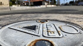 A metal lid covers a groundwater measuring device in Imperial Beach  on Feb. 6, 2023. 