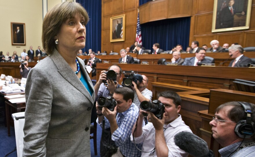 Lois Lerner, head of the IRS unit that decides whether to grant tax-exempt status to groups, leaves after being dismissed from a House Oversight and Government Reform Committee hearing on Wednesday.