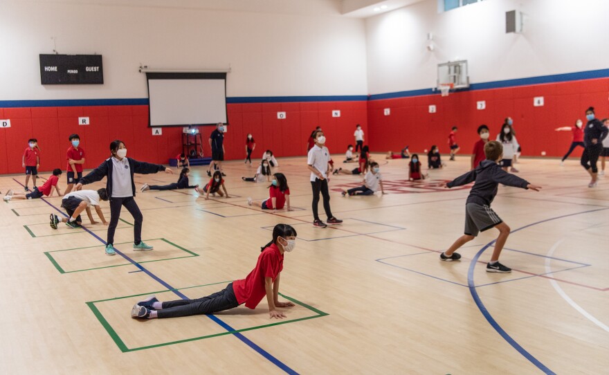 Students strike poses — while keeping a social distance — during a PE class at Hong Kong International School.