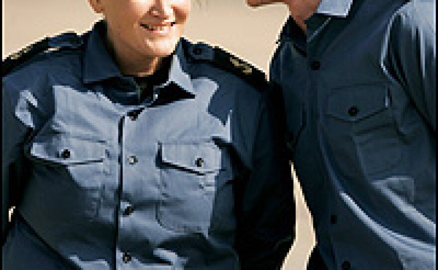 Having changed into fresh uniforms for the flight home, British crew members Faye Turney and Simon Massey chat at Heathrow airport in London.