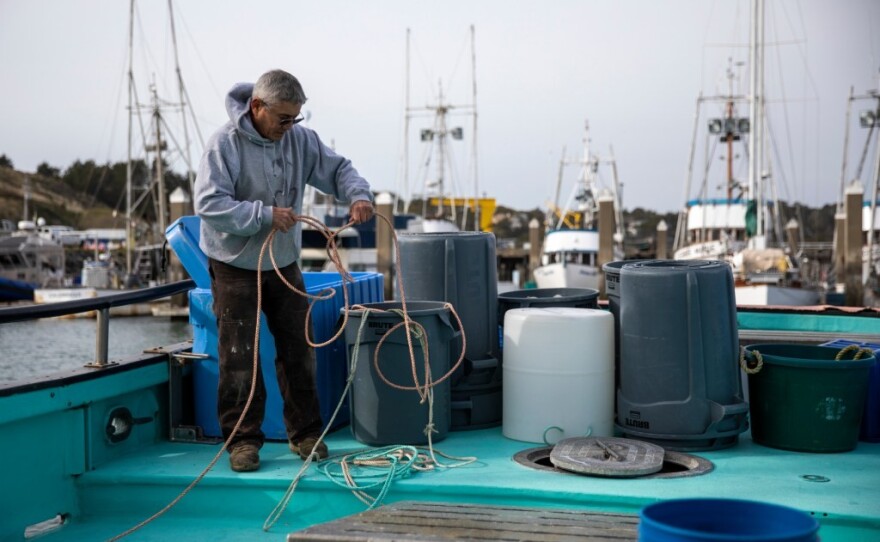 Fisherman Dick Ogg coils rope aboard his boat, the Karen Jeanne, in Bodega Bay on March 3, 2023.