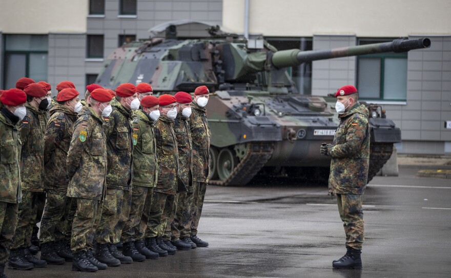 German Bundeswehr soldiers of the NATO enhanced forward presence battalion wait to greet German Defense Minister Christine Lambrecht upon her arrival at Lithuania's Rukla military base on Feb. 22. Germany's chancellor pledged to ramp up defense spending after Russia launched an invasion of Ukraine.