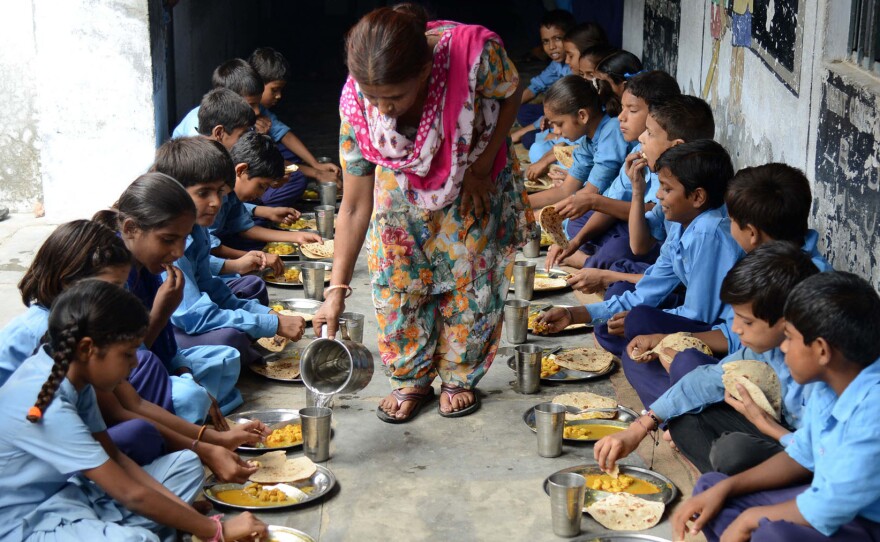 Indian schoolchildren eat their free midday meal.