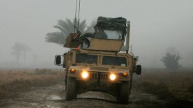 A U.S. soldier from the 6th Squadron, 8th Cavalry Regiment, mans a machine  gun on top of a Humvee as it navigates a muddy road on the southern outskirts of  Baghdad.