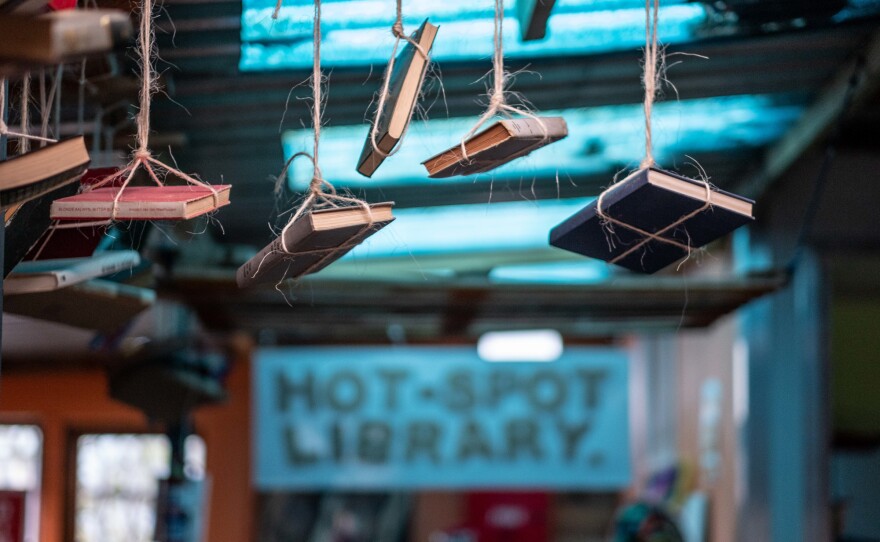 Decorative books hang from the ceiling in the Hot Spot Library.