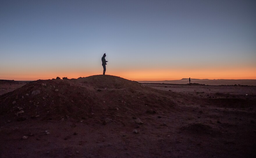 Illegal diamond miners try to get phone reception at a mining site in Namaqualand, South Africa.