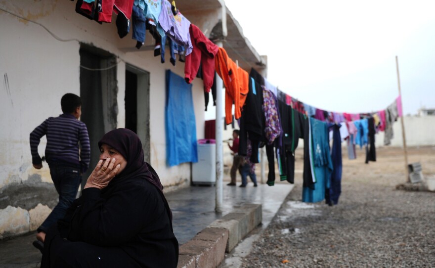 A Syrian woman sits in front of her house in a refugee camp in Reyhanli, near the Reyhanli border crossing with Syria, on Jan. 15.