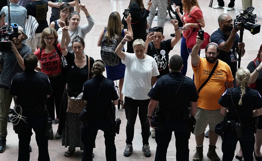 Activists chant during a protest outside the office of Senate Judiciary Committee Chairman Chuck Grassley of Iowa.