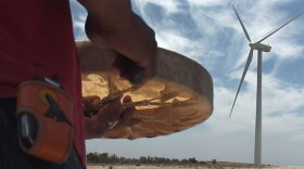 A Native drummer celebrates the construction of a wind turbine.