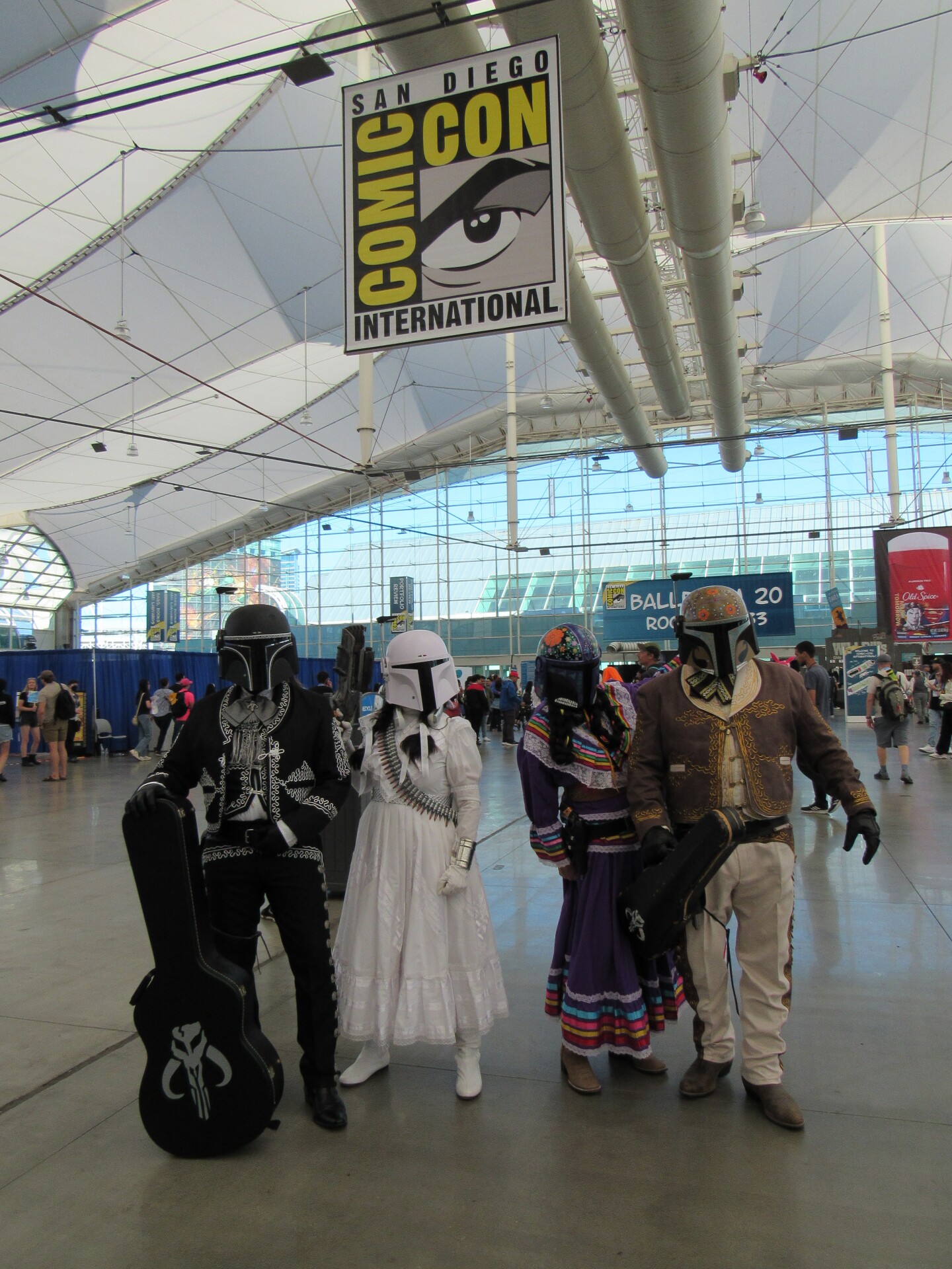 A group of Comic-Con attendees dressed as mariachi-inspired storm troopers stand under a Comic-Con banner on July 26, 2025.