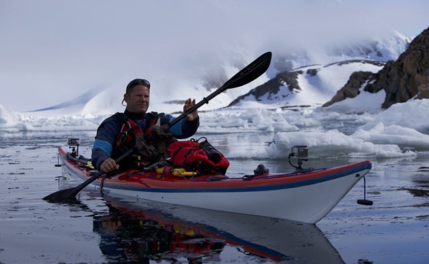 Steve kayaking through sea ice in Scoresbysund, Greenland. 