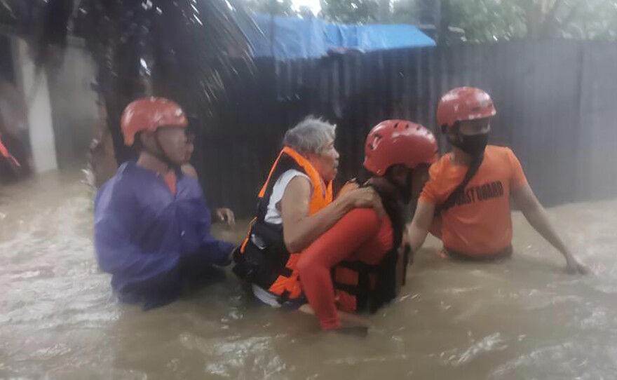 Rescuers evacuate residents to safer ground as floods caused by Tropical Storm Choi-wan hits Maasin City in Southern Leyte province, central Philippines. The tropical storm has left at least a few people dead and displaced hundreds of villagers in the southern and central Philippines.