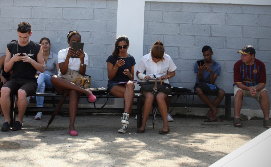 The Havana studio of prominent artist KCho is ringed by Cubans with their heads buried in screens. Users say the only other free Internet connection in Havana is at the U.S. Interests Section.