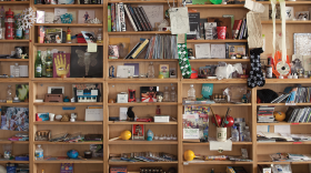 The bric-a-brac-stacked shelves of the Tiny Desk.