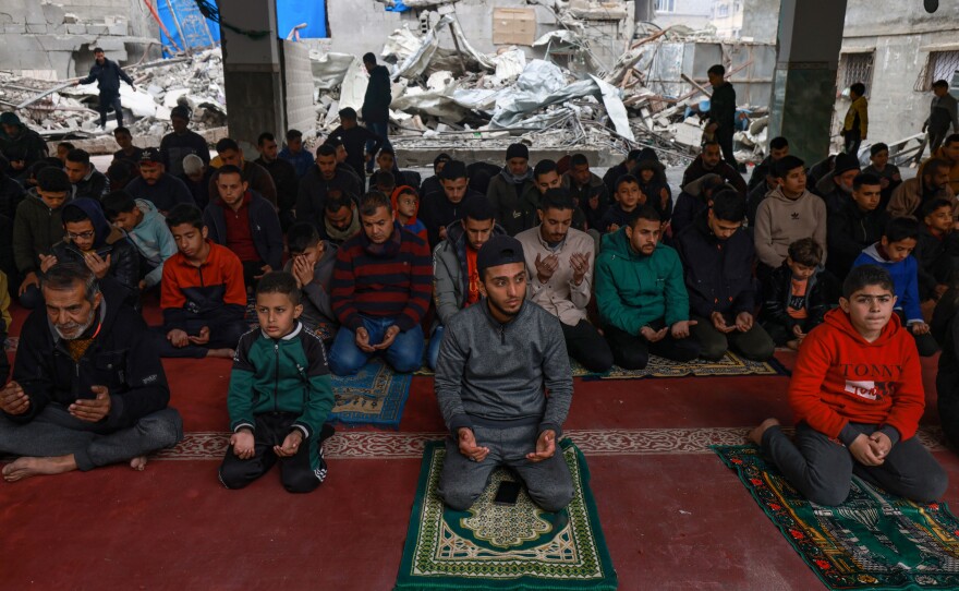 Palestinians perform Friday noon prayers at the Al-Hoda mosque, destroyed in Israeli bombardment in mid-February, after worshipers cleared rubble to make space for praying, in Rafah, the Gaza Strip, Feb. 23.