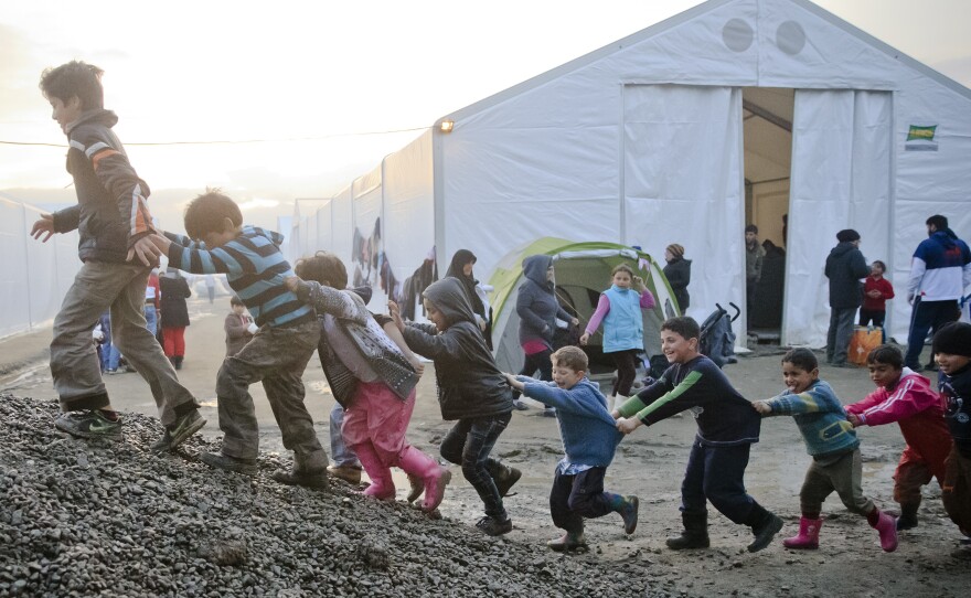 Children play on a pile of gravel at the northern Greek border point of Idomeni on Friday. More than 46,000 people are trapped in Greece, after neighboring countries stopped letting through refugees.