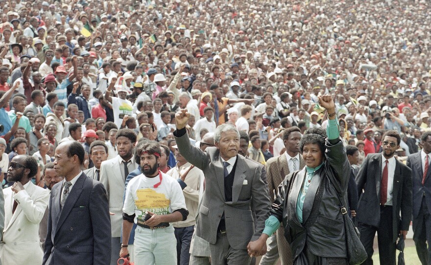 FILE Nelson Mandela and Winnie Mandela give Black power salutes as they enter Soweto's Soccer City stadium, South Africa Tuesday, Feb. 13, 1990. 120,000 thousand people packed the venue to hear his speech.