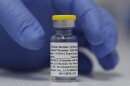 A vial of the experimental Novavax coronavirus vaccine is ready for use in a London study in 2020. Novavax's vaccine candidate contains a noninfectious bit of the virus — the spike protein — with a substance called an adjuvant added that helps the body generate a strong immune response.