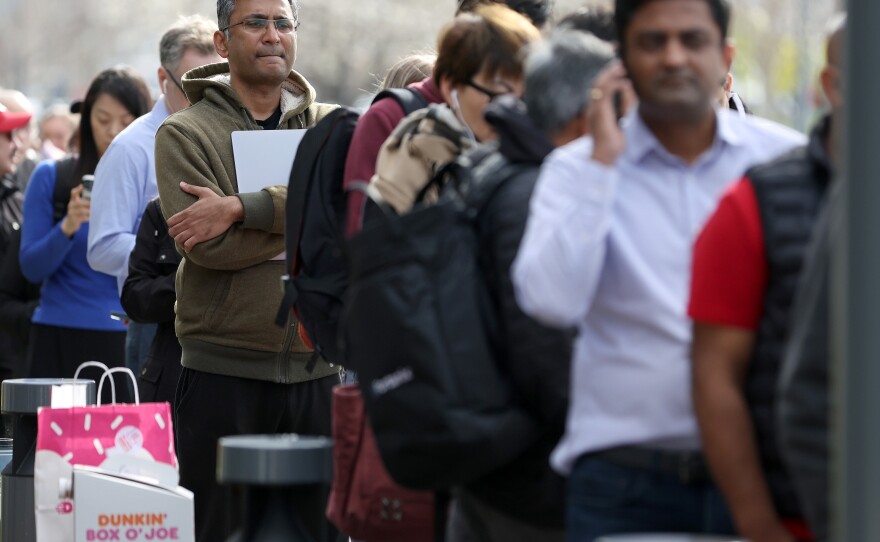 People line up outside of a Silicon Valley Bank office on March 13, 2023 in Santa Clara, Calif. U.S. regulators had stepped in to protect all deposits at SVB a day earlier, but worried customers still sought to retrieve their money from the lender and from other smaller banks.