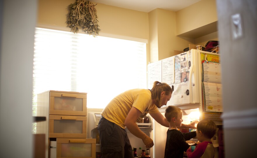 Jonathan prepares dinner for Egan and his friend while Zane is asleep upstairs.