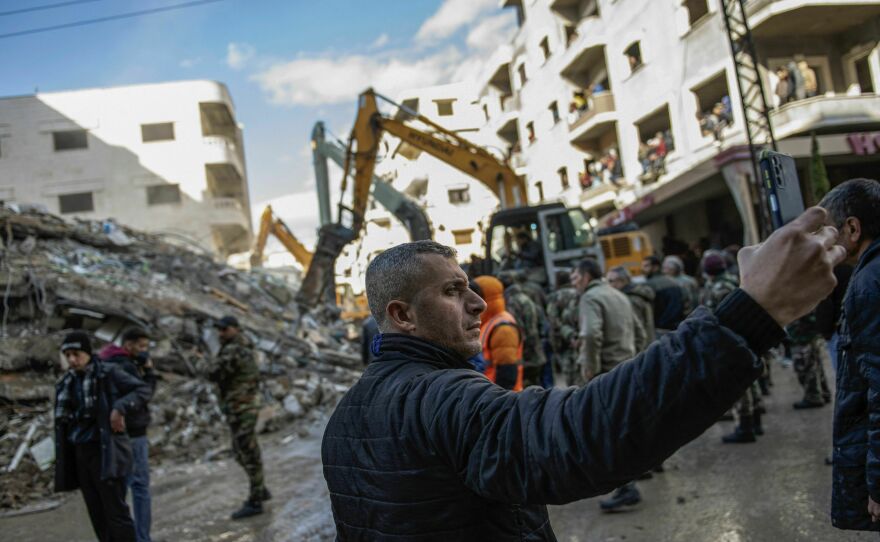 Rescue workers search for survivors in the rubble of a collapsed building in the town of Jableh in Syria's northwestern province of Latakia following the deadly earthquake.