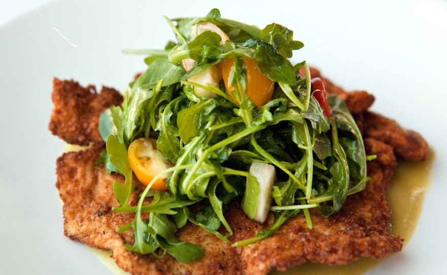 Crispy matzo-breaded chicken breast with a a salad of arugula, tomatoes and jícama with tamarind vinaigrette and salsa verde.