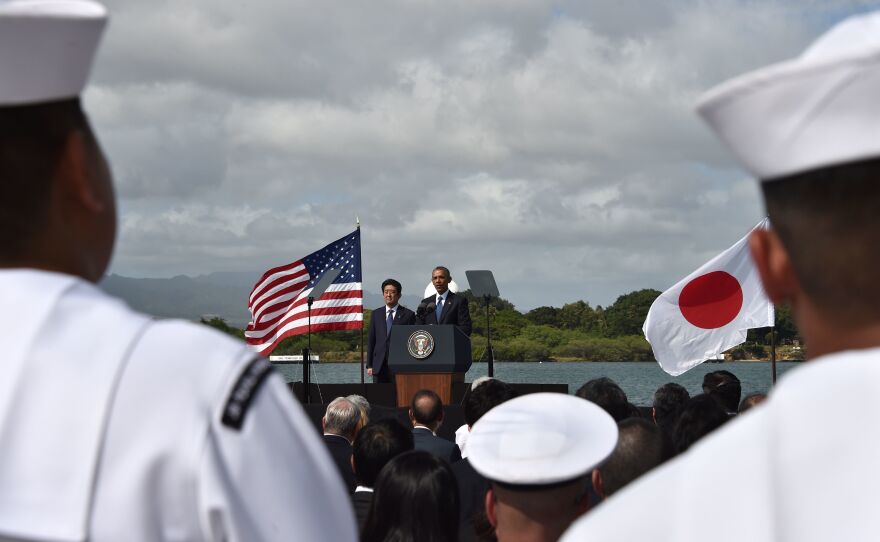 President Barack Obama speaks as Japanese Prime Minister Shinzo Abe listens at Kilo Pier overlooking the USS Arizona Memorial on Dec. 27, 2016, at Pearl Harbor in Honolulu, Hawaii.