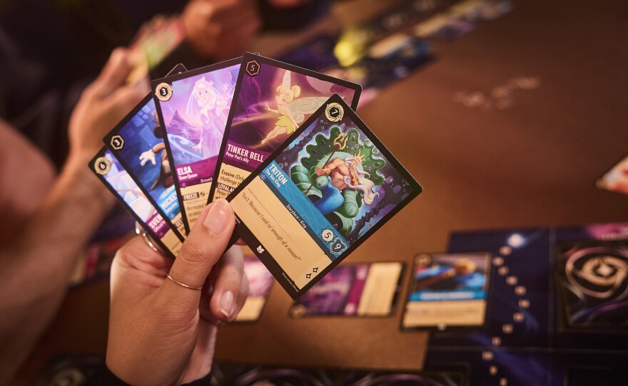 A grip of Sapphire and Amethyst Lorcana cards.
