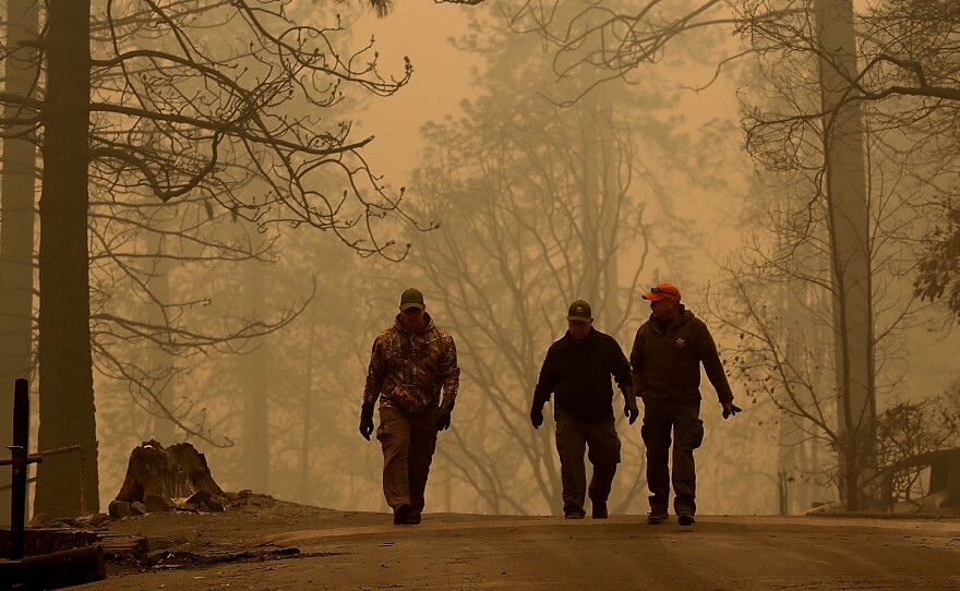 Sheriff deputies walk through a neighborhood destroyed by the Camp Fire near Paradise, Calif., on Nov. 10.