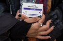 An abortion-rights activist holds a box of mifepristone pills as demonstrators from both anti-abortion and abortion-rights groups rally outside the Supreme Court in Washington on March 26, 2024.