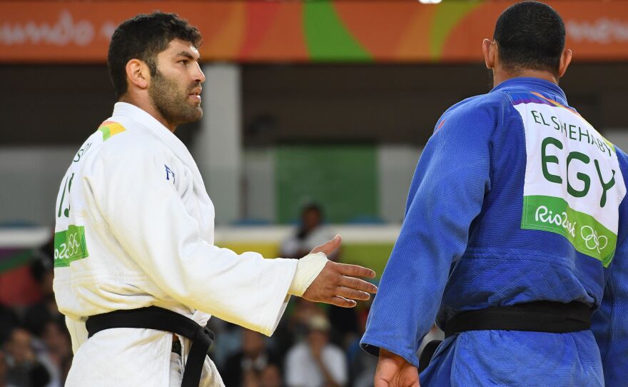 Israel's Or Sasson (left) ties to shake hands with Egypt's Islam Elshehaby during their men's 100kg judo contest match on Aug. 12.