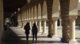 Students walk on the Stanford University campus on March 14, 2019, in Stanford, Calif.