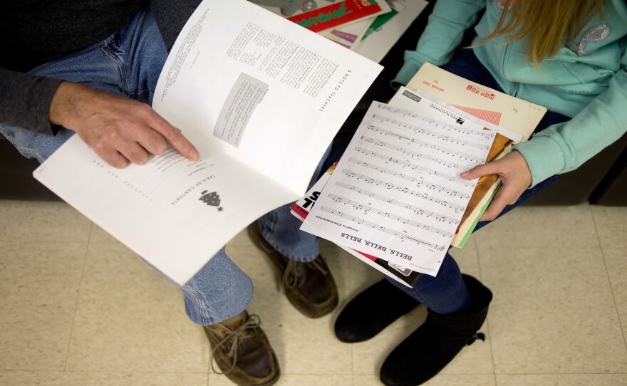 Major Chords for Minors instructor Bruce Leaman (left) and Paige Rosas, 12, look through music books to find some songs for Rosas to practice with during her piano lesson.