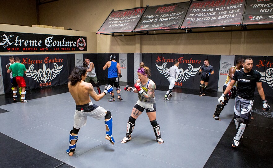 Mazany, center, spars with Puni Pagaoa during a training session. Many women in MMA regularly spar with male fighters.