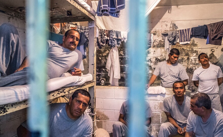 Sergio Gonzalez (top bunk, left) lies on his bunk in Tijuana's La Mesa prison, where he was jailed the previous February for holding more crystal meth than legally allowed. He is HIV positive as is his young son, Eduardo, who now lives in an orphanage.