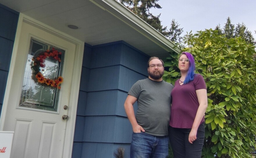 Alex Bacon and her husband, Eli Leslie, at their current house, which is very close to Seattle's airport. "I'm just off the end of one of the runways, so the air just smells of jet fuel," she says. The couple is scrambling to find a house to buy before mortgage rates go much higher.