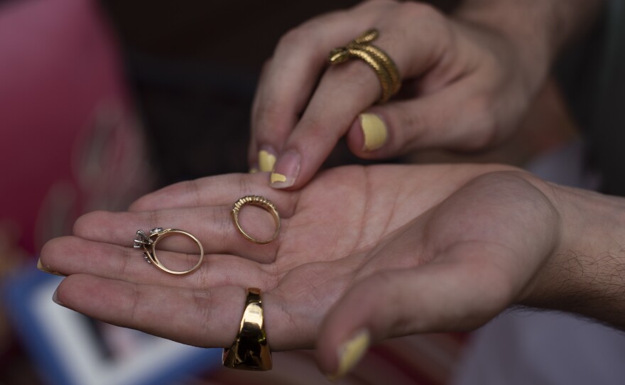 Michael Trerotola holds the rings his mother, Lisa, was wearing on the day she died, in front of his home in Morganville, N.J., on August 19.