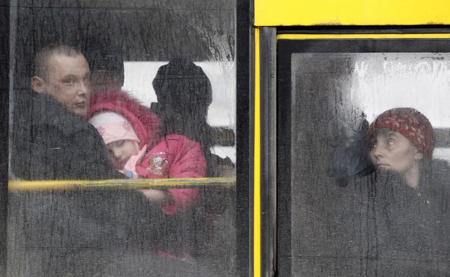 People wait on a bus to leave the town of Debaltseve, Ukraine, on Friday to escape the heavy fighting. Nearly 1 million Ukrainians have been displaced by battles between pro-Russian insurgents and government troops.