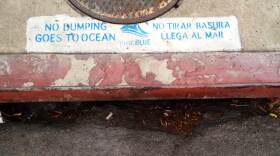 Trash and runoff go into a storm drain in Ocean Beach, Sept. 21, 2014.