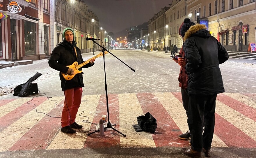 Guitarist Vitaly Abramov (left) plays for tips in downtown Kyiv. He sings in both Russian and Ukrainian.