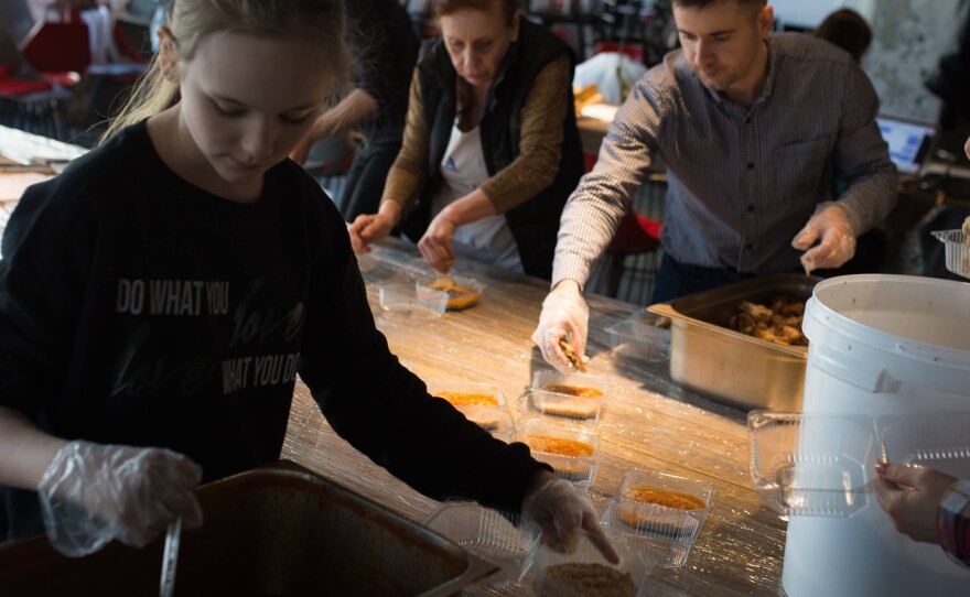 Volunteers, many of them forced to flee the war in other parts of Ukraine, pack meals for members of the country's Territorial Defense Forces in Moderna restaurant in Dnipro, Ukraine.