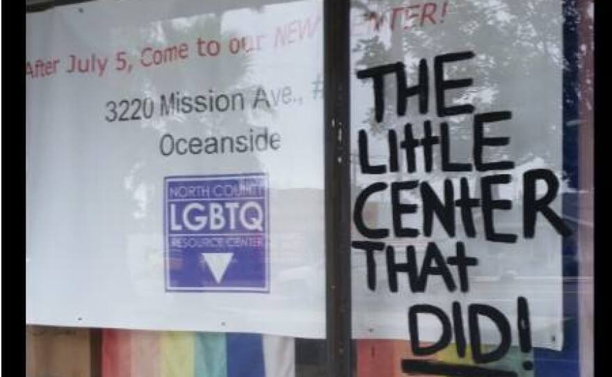 A sign telling North County LGBTQ Resource Center's visitors to drop by its new facility on Mission Avenue.