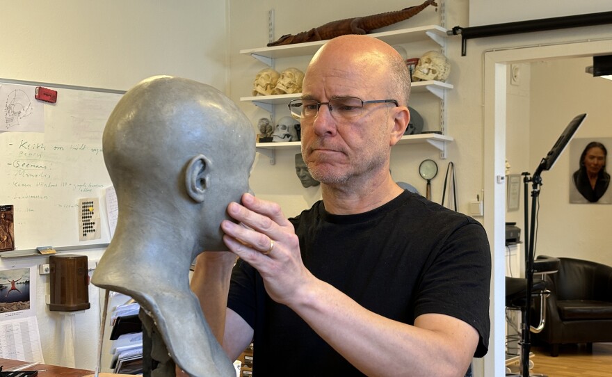 Sculptor Oscar Nilsson working on a facial reconstruction of the mysterious 350-year-old 'vampire' skeleton found in rural Pień, Poland.