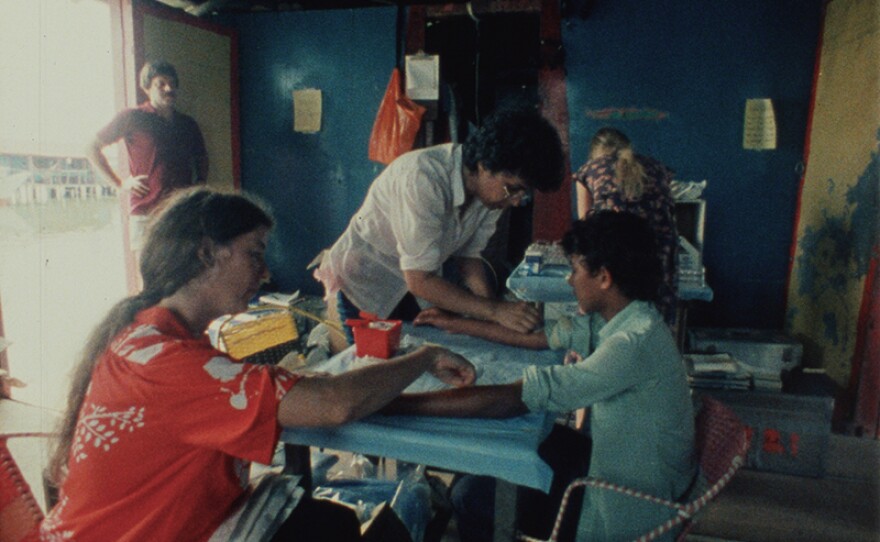 Anne Young and others on Nancy's Wexler's team draw blood from a young man in Venezuela. Wexler and her colleagues collected blood and skin samples in an effort to locate the gene responsible for Huntington's disease. The disease marker was discovered in 1983 only a few years after their search began, but the actual responsible gene wouldn't be identified until 1993.