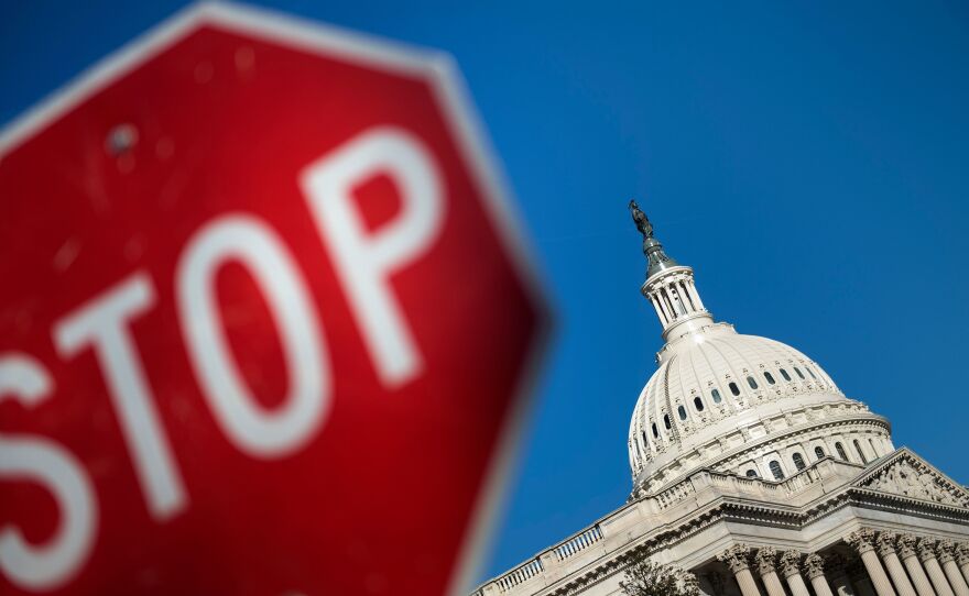 Capitol Hill is seen against a blue sky Saturday, the first day of the partial government shutdown.