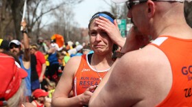 A runner reacts near Kenmore Square after two bombs exploded during the 117th Boston Marathon on April 15, 2013 in Boston, Massachusetts. 