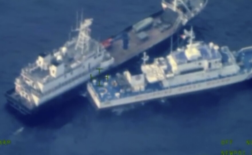 This image released by the Armed Forces of the Philippines, shows a Chinese militia vessel, top, and Philippine coast guard vessel BRP Cabra as they approach Second Thomas Shoal, locally called Ayungin Shoal, at the disputed South China Sea on Sunday Oct. 22, 2023.